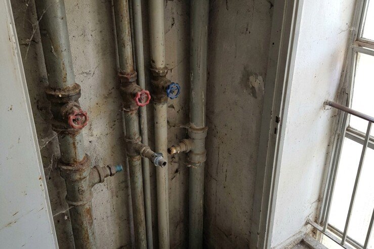 צנרת מים וביוב ראשית בפיר השירות של בניין משותף